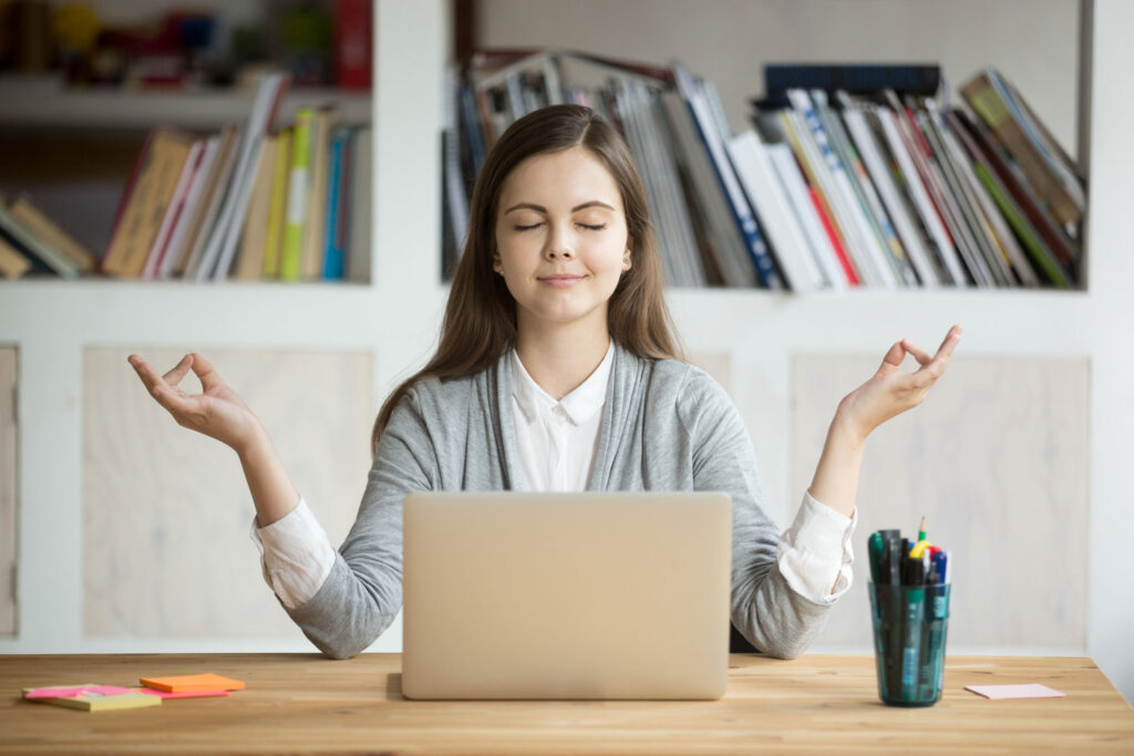 Calm woman relaxing meditating with laptop