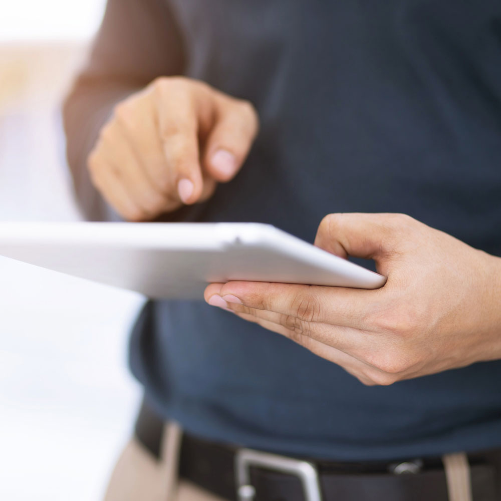 close up hand businessman working using a digital tablet pc device